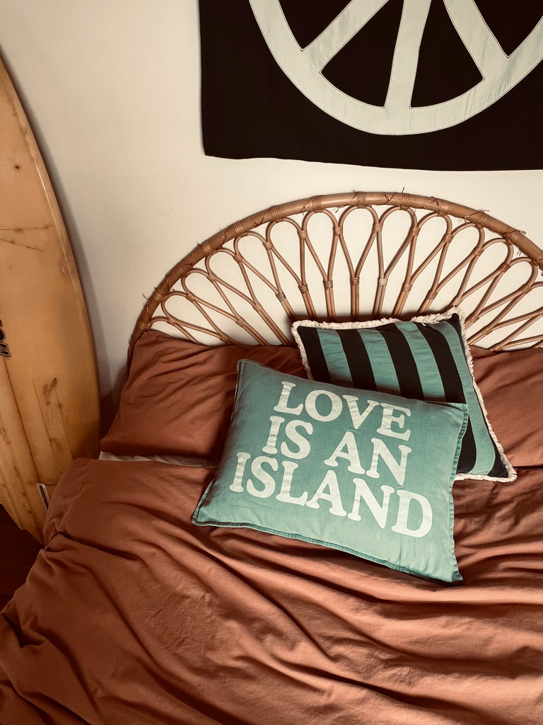 med stripe cushion | rust + teal